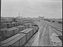 Black and white panorama of trains in a railway yard