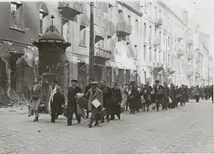 NARA copy #6, IPN copy #6March to the rail stationColumn heading North to Umschlagplatz on Zamenhofa Street near Kupiecka. In the back buildings of Zamenhofa 30-40 block.