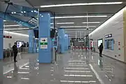 Station concourse with faregates in the background