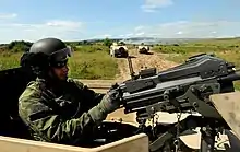 A member of the 5th Special Forces Regiment conducts security inside HMMWV