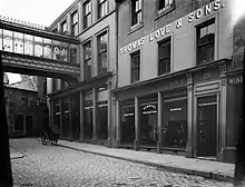 A late-19th-century view of the now-demolished Thomas Love & Sons at 12–19 St John's Place, looking west towards King Edward Street