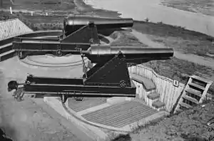 An 8-inch (200-pounder) Parrott rifle at Battery Rodgers Alexandria, Virginia mounted on a front pintle, barbette carriage. The gun in the background is a Rodman gun mounted on a center pintle, barbette carriage.