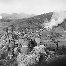 Image 65Soldiers from 3 RAR watch as a Korean village burns in late 1950 (from History of the Australian Army)