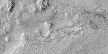 Surface breaking up, as seen by HiRISE under HiWish program  Near the top the surface is eroding into brain terrain.