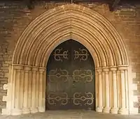 Buff-coloured basalt and limestone doorway to the CNI Afghan Church.