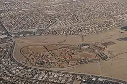 Aerial color photograph including sports fields surrounding a complex of school buildings