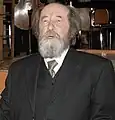 Aleksandr Solzhenitsyn with his mouth open and lower teeth on show