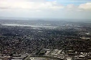 Aerial view of Māngere East, with the Māngere Inlet and Ōtāhuhu in the background (2009).