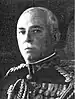 An image of a white male in his military uniform with no hat on. Military style medals are clearly visible.