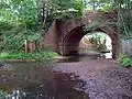 The river passes beneath the railway, north of Fulliford Passage