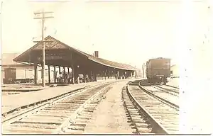 A black-and-white postcard of a small railway station