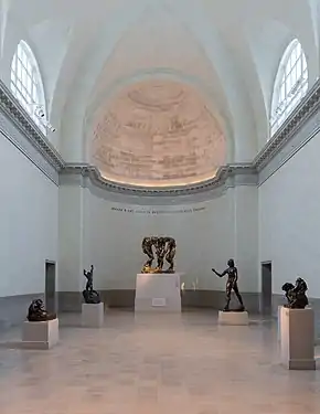 The Spreckels Gallery showcasing bronzes by Rodin; the pipes of the symphonic organ are hidden behind the trompe-l'œil canvas apse.