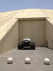 A Mercedes-Benz atop a massive chassis at the Emirates National Auto Museum.