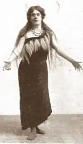 young white woman with long dark hair in full-length, extravagant operatic costume