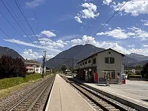 Two-story building with gabled roof next to railway line