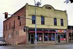 Photograph of the Cheney Odd Fellows Hall, a two-story, brick, commercial building on a city street corner