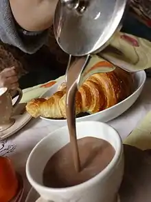 Image 15Hot chocolate served with a croissant (from List of drinks)