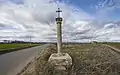 A Christian cross in border of a road