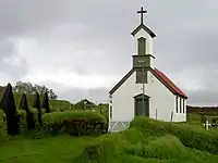 The Keldnakirkja church. Gables of turf houses in the village can be seen on the left.