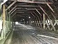 (image 6 of 9)2018Viewed from the Cornish side.The lattices are the diagonal beams on the sides attached to the chords (horizontal beams running, lengthwise, parallel to the floor planks); from top to bottom – the primary upper chord, the secondary upper chord, the secondary lower chord, and the primary lower chord.