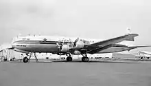 A black-and-white photograph of a JAL Douglas DC-6