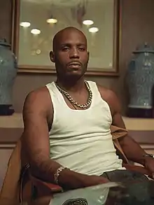 Man sitting in front of a brown background.