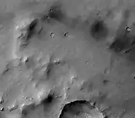 Dawes Crater floor with fresh impact craters, as seen by HiRISE.  Click on image to see dark ejecta from some craters that formed when the impact reached a dark layer