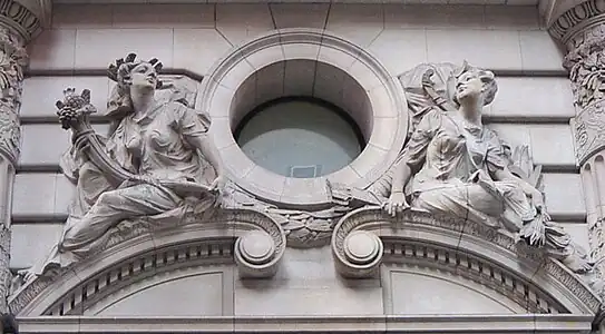 Beaux-Arts building decoration presenting images of the Roman goddesses Pomona and Diana. Note the naturalism of the postures and the channeled rustication of the stonework.