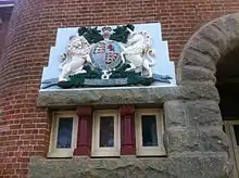 Royal coat of arms and Dieu et mon droit motto near entrance