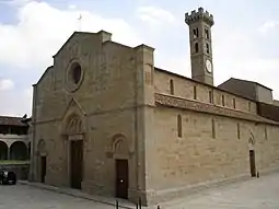 Angled view of the brown, stone facades of the front and side