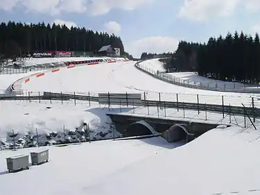 The bridge where the Circuit de Spa-Francorchamps crosses the Eau Rouge stream is located at the corner bearing its name. The right-hand turn visible in the background leading up the hill is Raidillon.