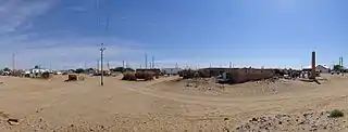 A panorama from the entrance to the village of Erbent (Yerbent). On the right side of the photo a group of tourists standing next to the Basmachi Revolt monument can be seen.