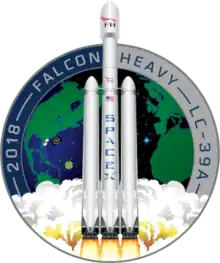 Artistic depiction of a Falcon heavy rocket launching from the Earth, represented in the background by a circular patch.