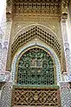 Decoration on the outer south wall of the mausoleum, and a slot opening (bottom) for giving alms