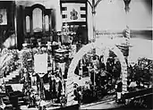 Interior of church with mourners and kahili (feather standards)