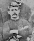 Black and white image of Williams wearing his cap posing before a match