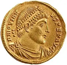 Golden coin depicting man with diadem facing left