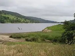 Image of a lake with steep hills beyond