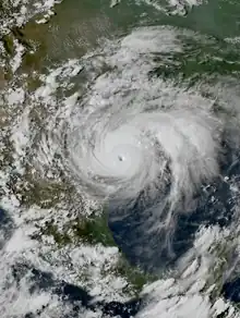 Satellite image of a powerful tropical cyclone nearing the coast of southern Texas, with an eye clearly visible