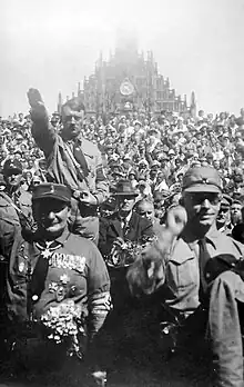 Adolf Hitler with the Nuremberg Frauenkirche in the background, 1928