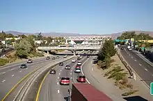 A 6-lane freeway passing under a series of underpasses