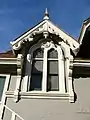 Twin windows with the Moss and the Wood family coats of arms in stained glass