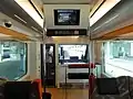 Interior view of HB-E301-3, showing ceiling-mounted monitor screens in June 2011