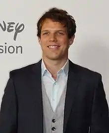 Jake Lacy wearing suit and vest.