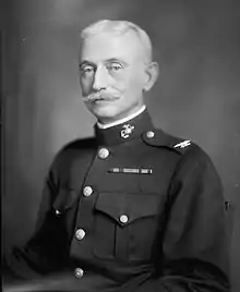 An image of a white male in his military uniform with no hat on. Military style ribbons are clearly visible.