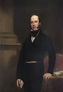 Standing three-quarter length painted portrait of James Haughton Langston, formally dressed in black, holding papers in his right hand and resting his left hand