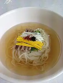 Janchi-guksu topped with egg garnish strips