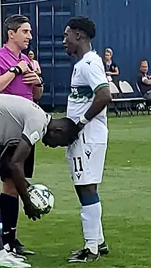 A referee talking with a player