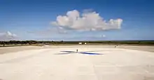 A person standing in the middle of the main landing pad demonstrates its size