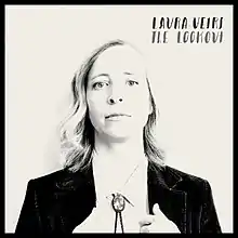 A black-and-white photo of Veirs' face